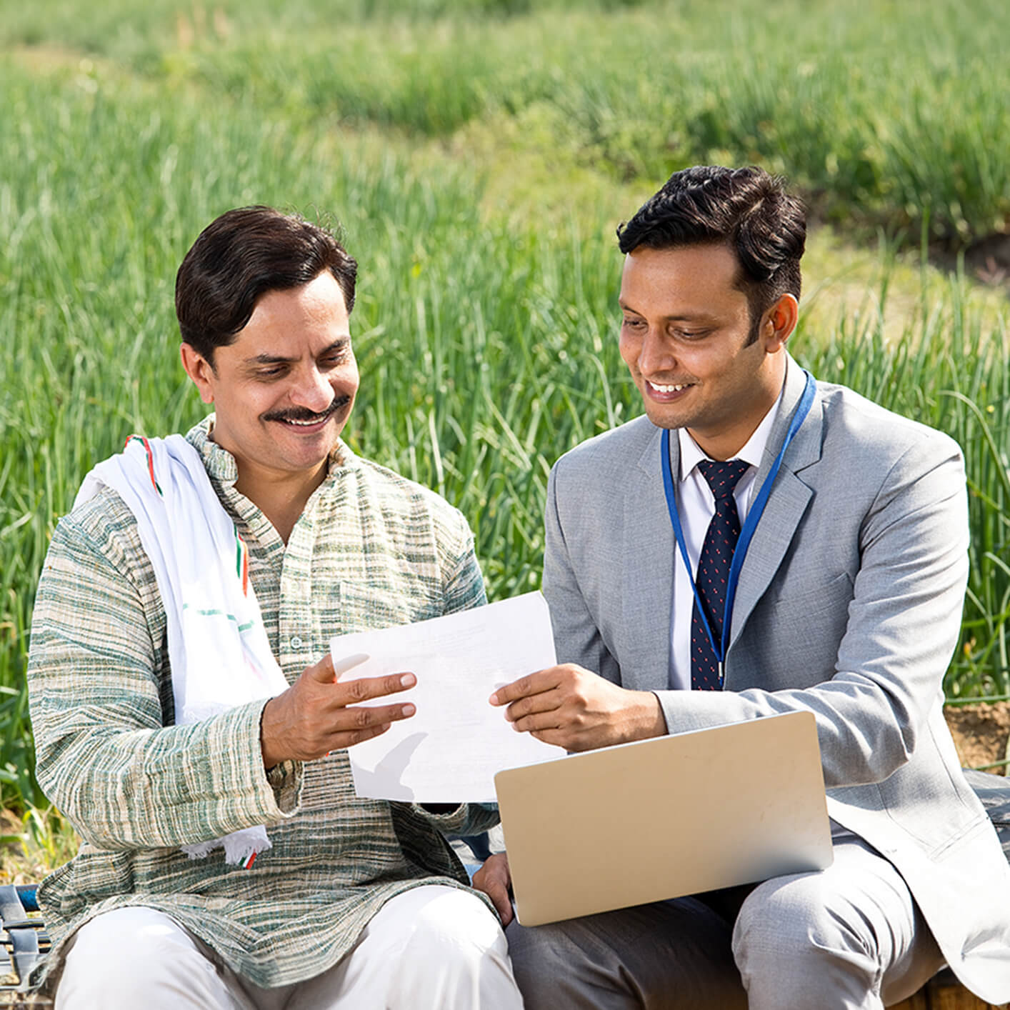 Two professionals discussing research in a field setting